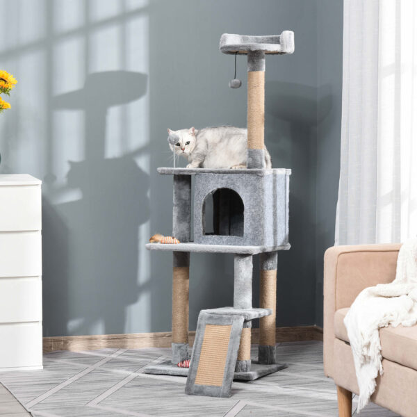 grey cat climbing tower with condo